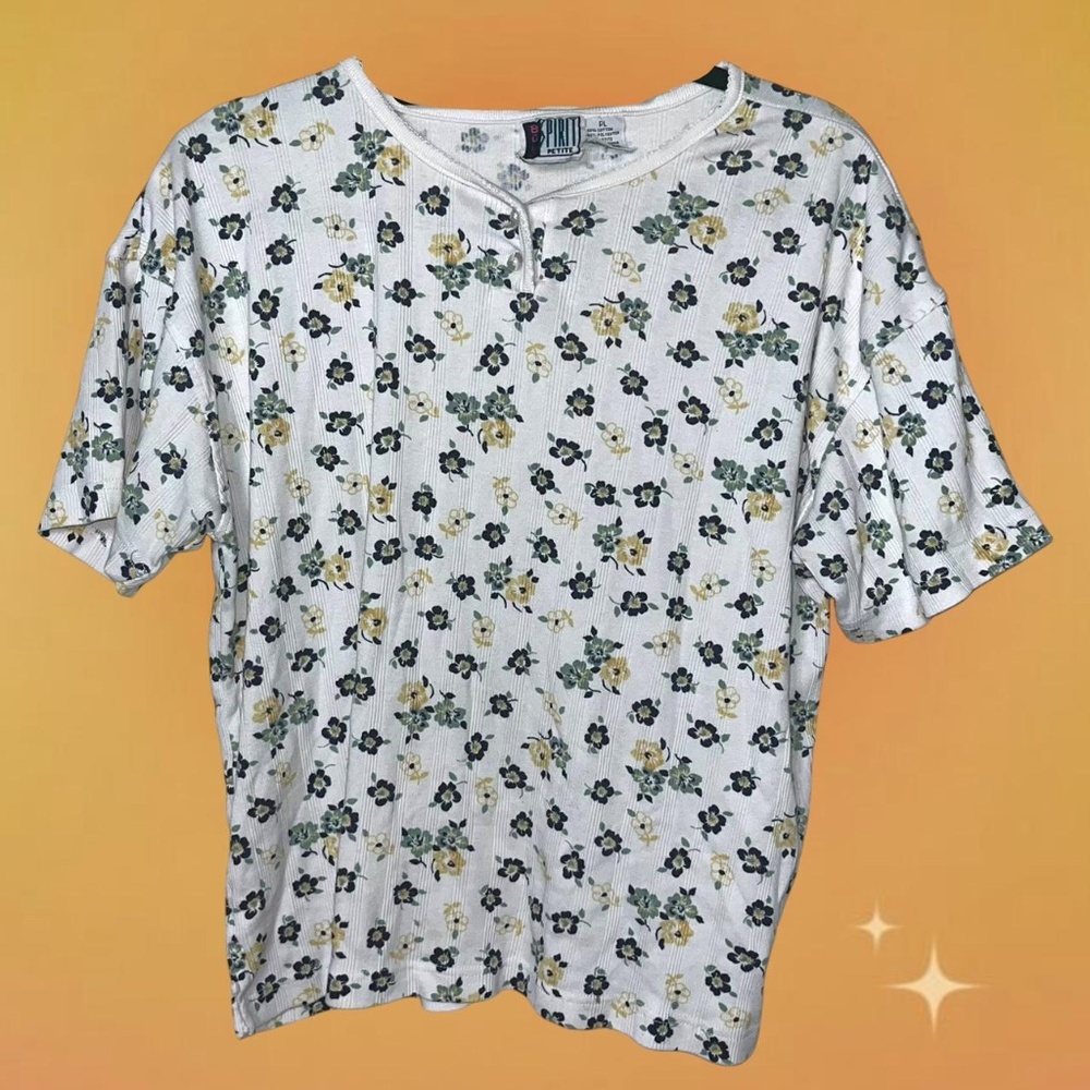 White and green floral tshirt with button-up details   Measurements: Bust 46 in.